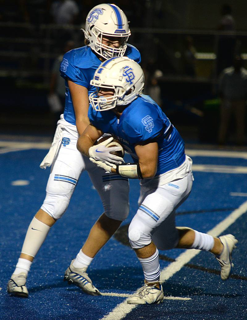 St. Francis's Allessio Milivojevic hands the ball off to Brady Piper during their home game against Sterling Friday Sept 2, 2022.