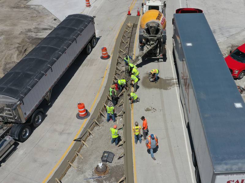 Crews pour concrete on the northern approach to the roundabout on Tuesday, May 16, 2023 at the intersection of Illinois Route 178 and U.S. Route 6 in Utica.