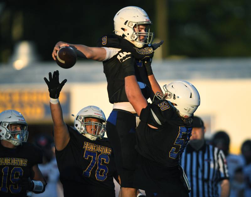 John Starks/jstarks@dailyherald.com
Warren quarterback Adam Behrens is lifted by teammate Kole Weinberg after scoring early against Barrington in Gurnee on Friday, August 26, 2022.