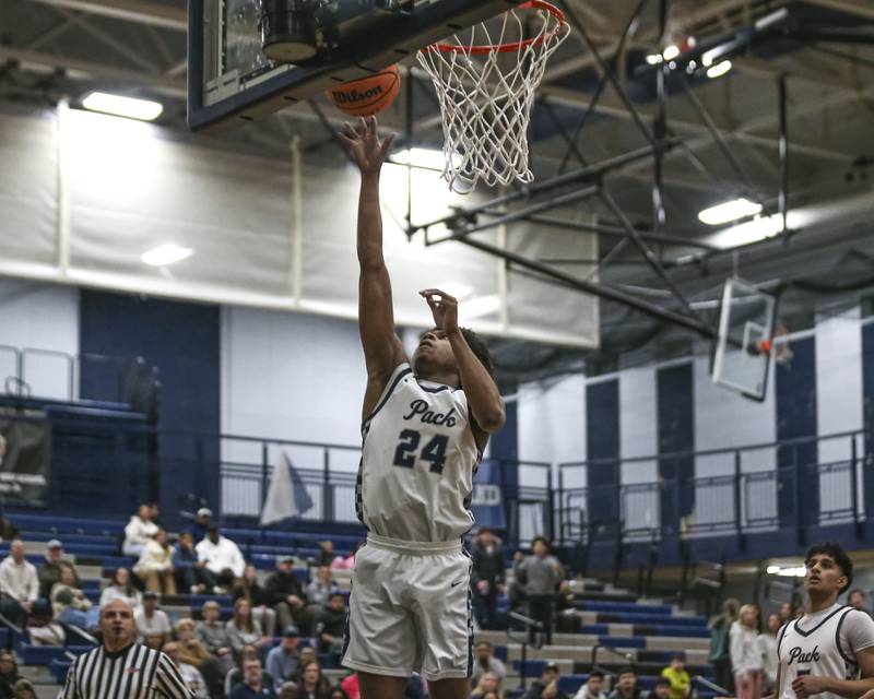 Oswego East's Dshaun Bolden (24) puts in a layup during their basketball game between Yorkville at Oswego East. Friday, Dec 19, 2025 in Oswego.