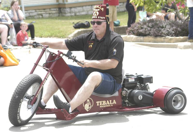 A Shriner entertains the crowd during the Dixon Petunia Fest parade on Sunday, July 6, 2025.