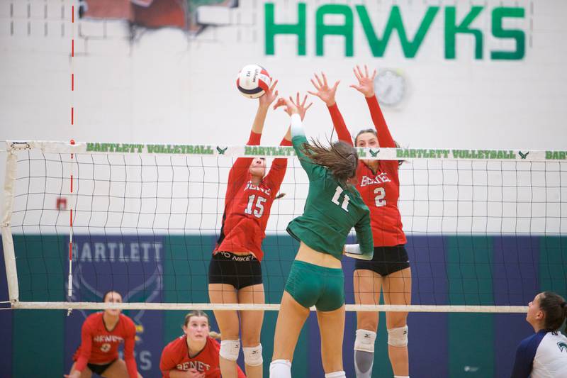 Benet's Sophia Chinetti (15) and Gabby Stasys (2) blocks the shot by New Trier's Ana Vetter at the Class 4A Super Sectional Final on Friday, Nov.3,2023 in Bartlett.