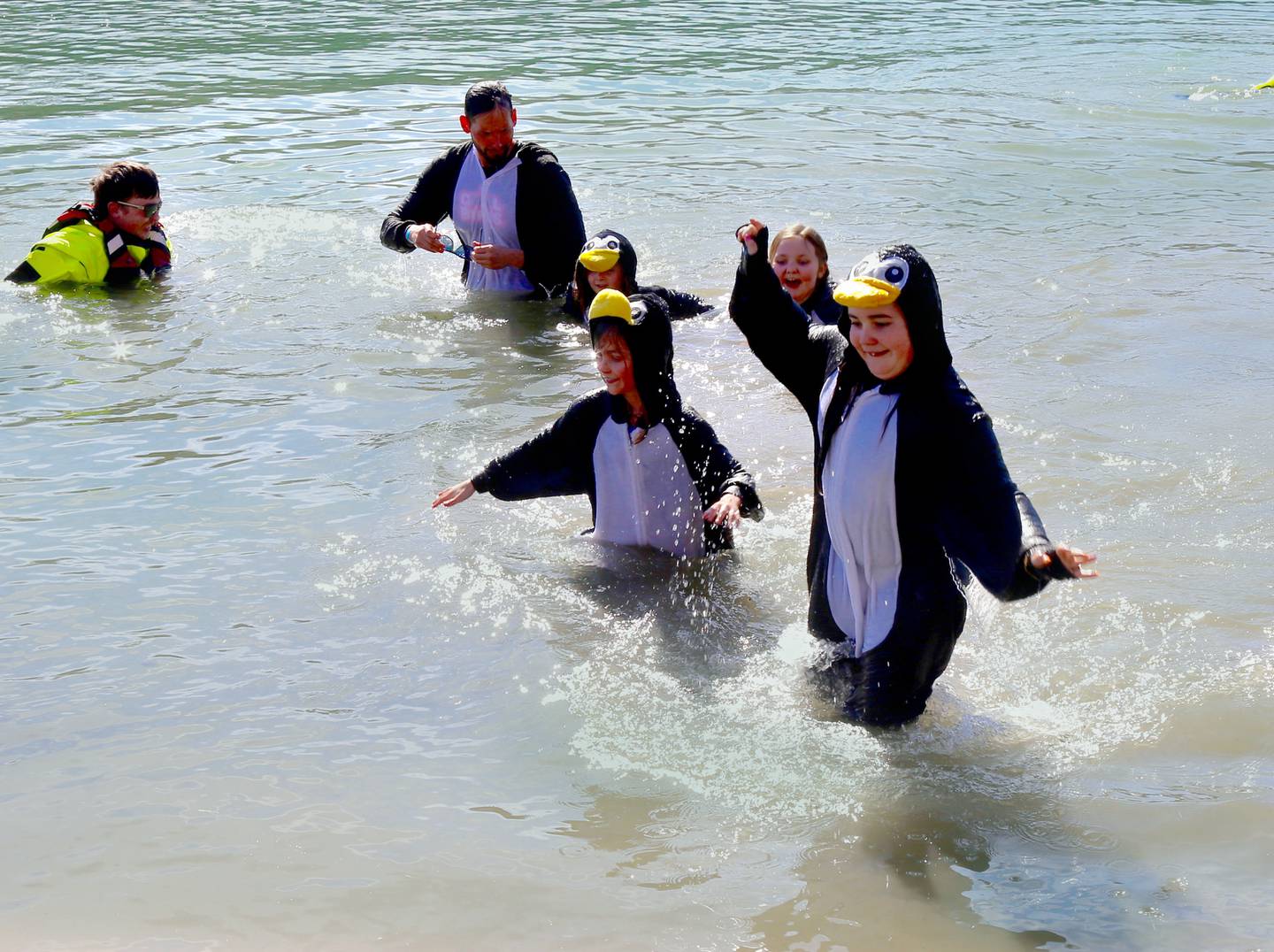 The Chilly Penguins (l-r; Shane, Rocky, And Maeve Diaz, Bria Giron and Eloise Nelson) participate in the Yorkville Polar Plunge on Sunday, March 2, 2025.