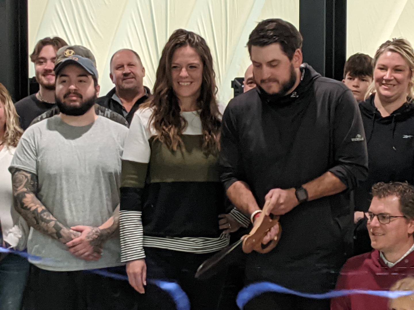 Alex Balog, director of golf operations for Yorkville-based Whitetail Ridge Golf Club, cuts the ribbon during the grand re-opening of the Whitetail Ridge Golf Dome in Oswego on Nov. 1. The Oswego Area Chamber of Commerce hosted the event,
