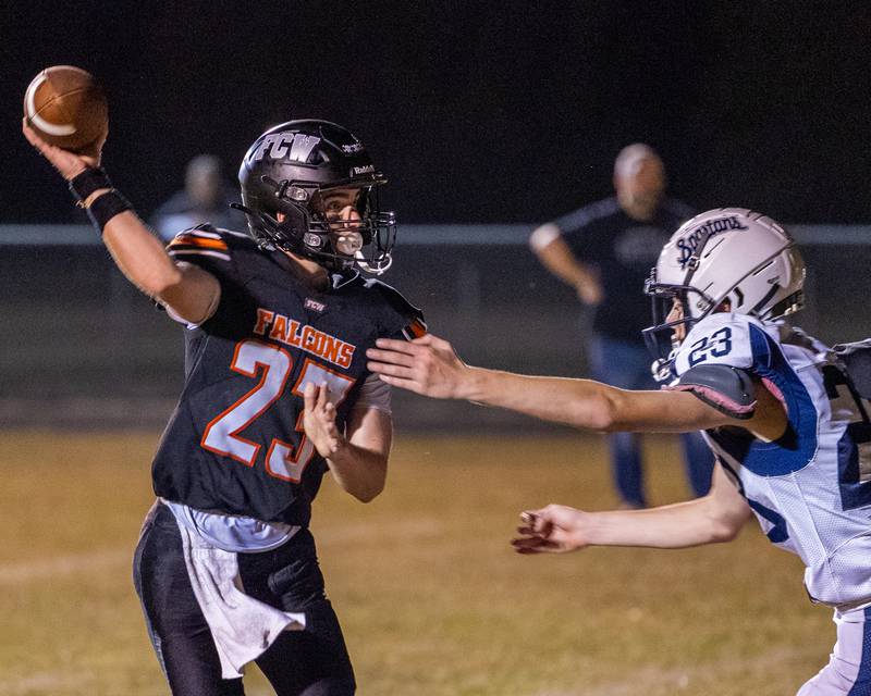 Brezdyn Simons (23) of FCW throws football as Cam Galle (23) of Ridgewood looks to tackle on Friday, Sept. 26, 2025 at Woodland High School in Streator.