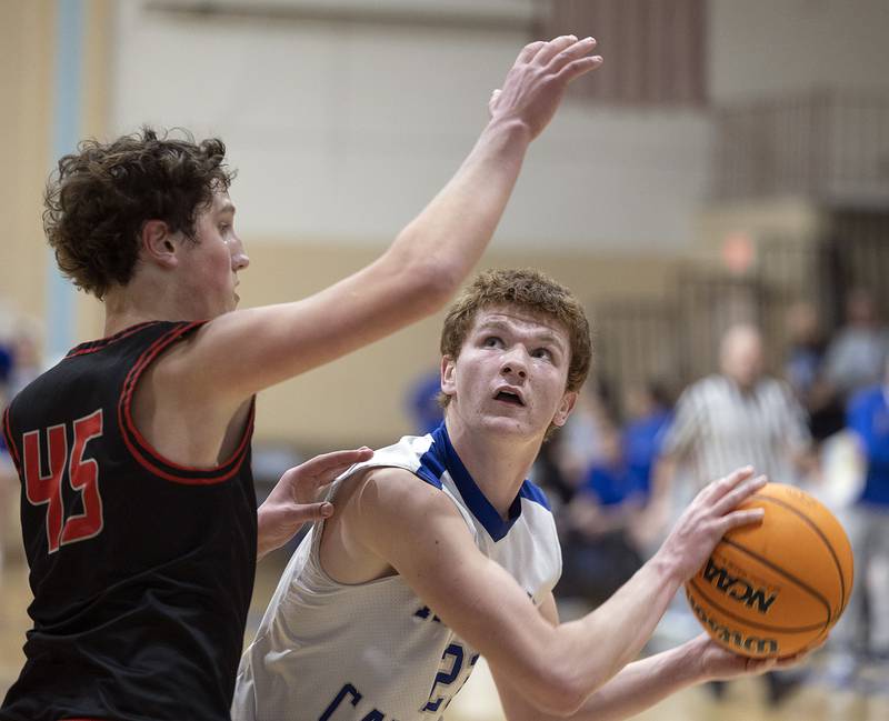 Newman’s John Rozwee looks to put a shot against Erie-Prophetstown’s Gus Schultz Wednesday, Jan. 29, 2025, at Newman High School.