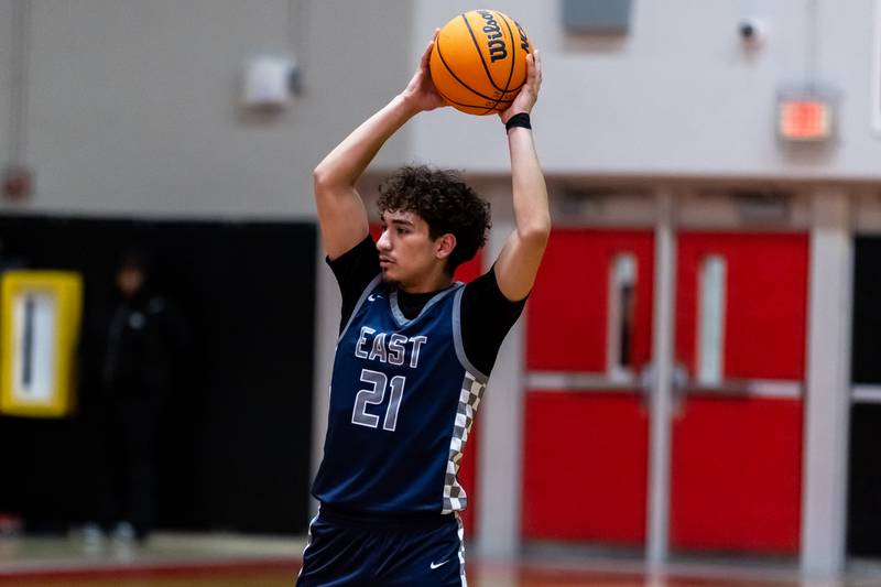 Oswego East's Juan Zavala looks for an open teammate during a varsity boys basketball game against Bolingbrook at Bolingbrook on Dec. 12, 2025.