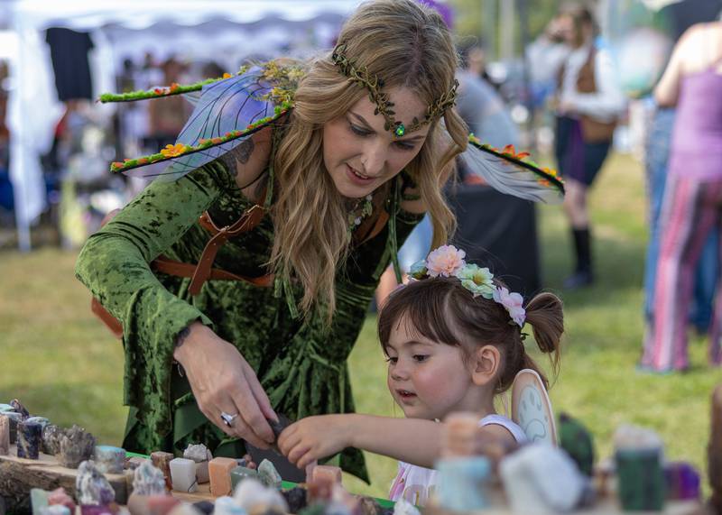 Lauren Lindeman (left) helps Cece Brown, 3, pick out a rock at a vendors table at the Marseilles Renaissance Faire on September 13, 2025 in Marseilles.