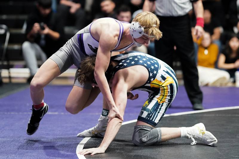 Plano’s Caidan Ronning (left) fights for position against Yorkville Christian’s Robby Nelson during their 157 pound championship bout in the Plano Reaper Classic Wrestling meet at Plano High School on Saturday, Dec. 14, 2024.