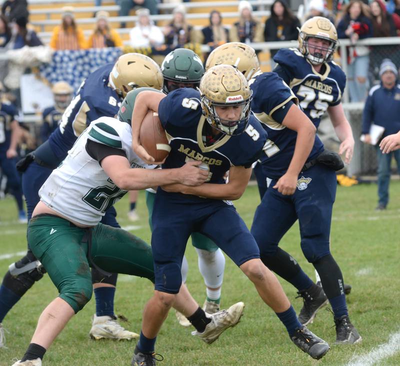 Polo's Gus Mumford (5) runs for a gain against West Carroll during 8-man football playoff action on Saturday, Nov. 9, 2024 at Polo High School.
