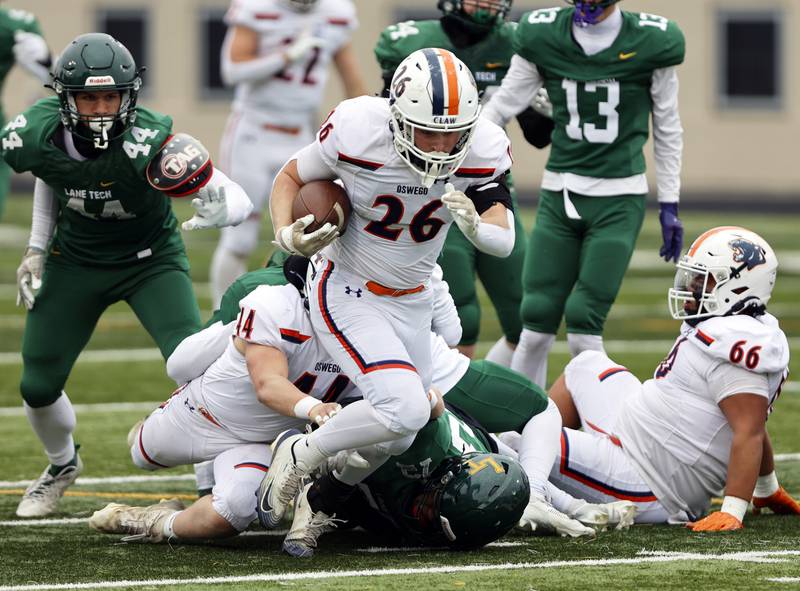 Oswego's Dekker Zelensek (26) runs with the ball during the varsity football second-round 8A playoff game between Oswego and Lane Tech on Saturday, Nov. 8, 2025 in Chicago.