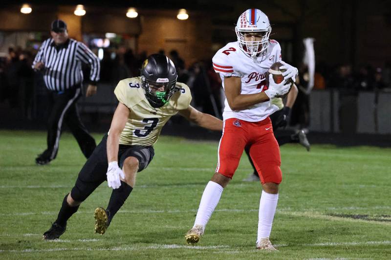 Ottawa's Andrew Vercolio catches a pass and is immediately tackled by Sycamore's Carter York during their game Friday, Sept. 27, 2024, at Sycamore High School.