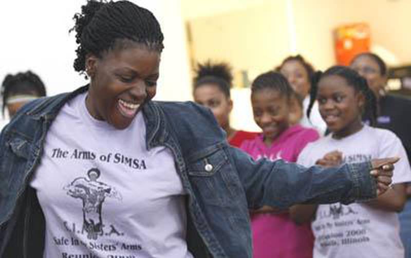 Shaw Local 2008 file photo - SIMSA, or Safe In My Sister’s Arms, Director LaMetra Curry dances in the center of a circle of SIMSA/SIMBA members during their monthly gathering June 8, 2008 at New Hope Missionary Baptist Church in DeKalb. The message of the 87-member group is of love. “We love you, we really do,” the group sang as they swayed together.