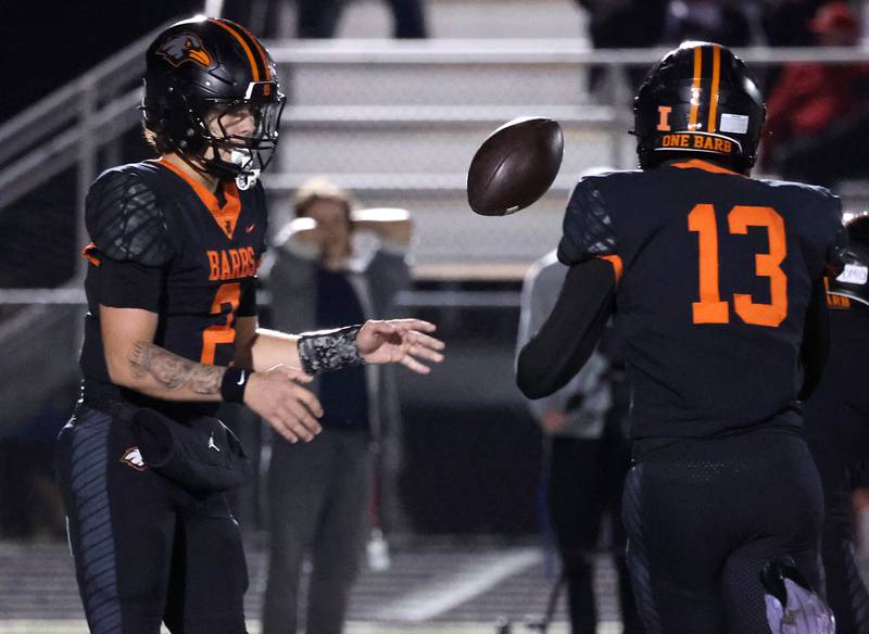 DeKalb's Cole Latimer flips the ball to Davon Grant who tries to get outside of the Andrew defense during their game Friday, Oct. 16, 2025, at DeKalb High School.