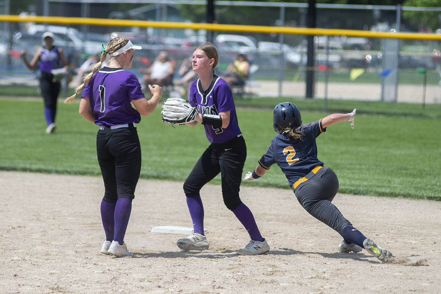 Sterling’s Nevaeh Frey swerves around Dixon’s Ava Valk to make it to second base on a fielders choice Saturday, May 28, 2022.