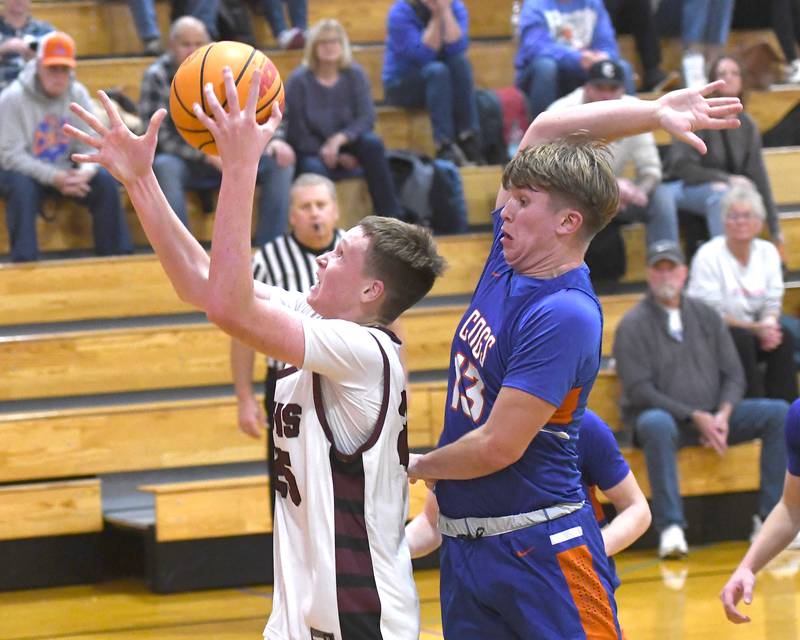 Marengo's Parker Weadge (25) shoots as Genoa-Kingston's Conner Harney (13) tries to get a piece of the ball on Monday, Nov. 24, 2025 at  the Oregon Boys Basketball Thanksgiving Tournament in Oregon.
