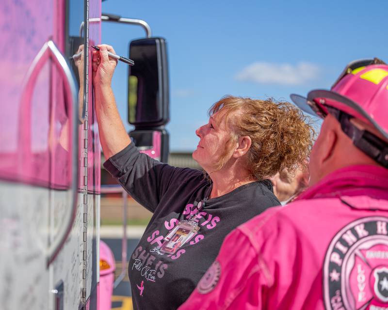 Sherry Tipton signs the Pink Heals Truck for her mother who is battling breast cancer on Wednesday, Oct. 8, 2025 at the LaSalle County Nursing Home in Ottawa.