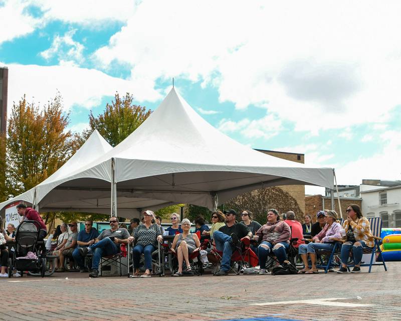 Community members try a variety of samples at the annual Taste of DeKalb while enjoying a performance from The Prissillas on Sunday, Sept. 29, 2024, held in downtown DeKalb.