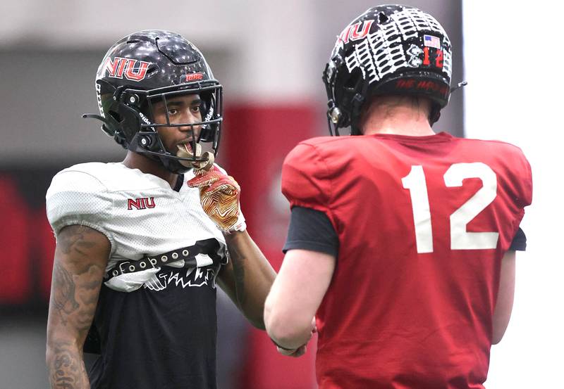Northern Illinois University receiver Fabian McCray talks to quarterback Rocky Lombardi during spring practice Wednesday, April 6, 2022, in the Chessick Practice Center at NIU in DeKalb.