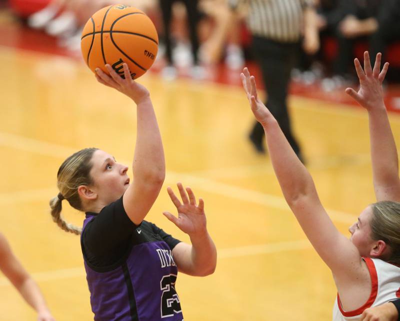 Dixon's Presley Lappin shoots a jump shot over Ottawa's Kennedy Kane on Wednesday, Dec. 3, 2025 in Kingman Gymnasium at Ottawa High School.