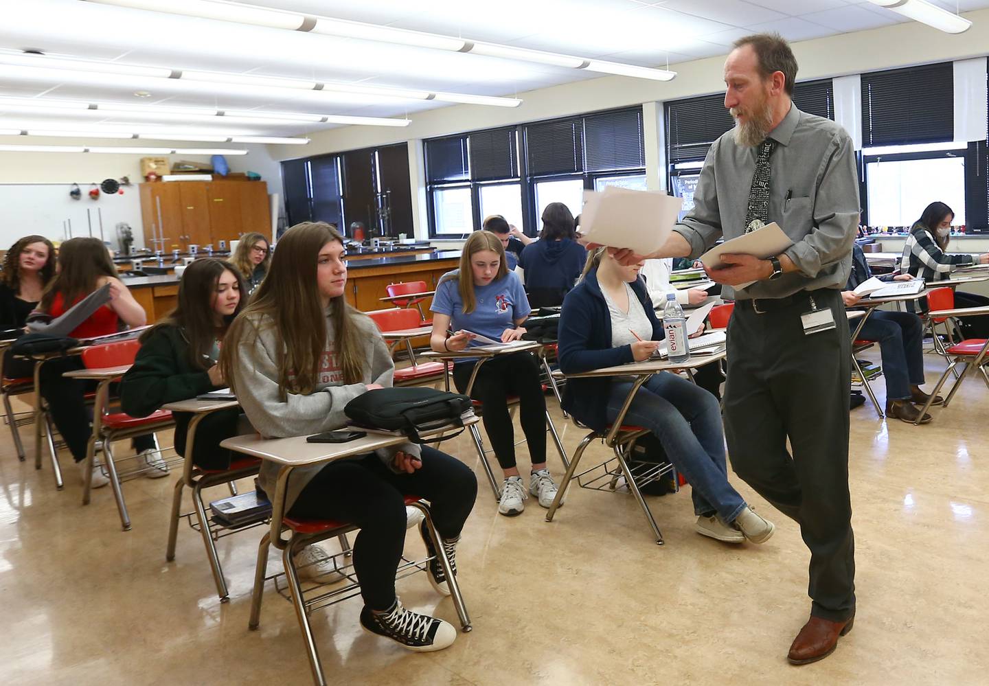 Bryan Leonard, chemistry teacher at Ottawa Township High School, hands out an assignment on electronic configurations on Tuesday March 29, 2022 in Ottawa. Leonard, has been teaching for 28 years and has seen changes in technology and how kids process information and he has tried to keep up with it.