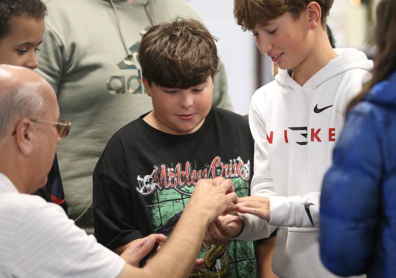 Students Jack Justi and Joe Steele holds Gary Pressy's 2016 Chicago Cubs World Series ring on Tuesday, Oct. 29, 2024 Lincoln Jr. High School in La Salle. Retired organist Gary Pressy played "Take Me Out To The Ballgame" to students. Pressy was organist for the Chicago Cubs from 1987-2019. Pressy began playing the piano at age 5. He started his career with the Cubs on April 1, 1987. Pressy never missed a game in 33 years. "I've played 2,687 games and never missed one, said Pressy. Pressy held a question and answer session while visiting the school. He told the students "If you have a dream reach for the stars but keep your feet on the ground."
