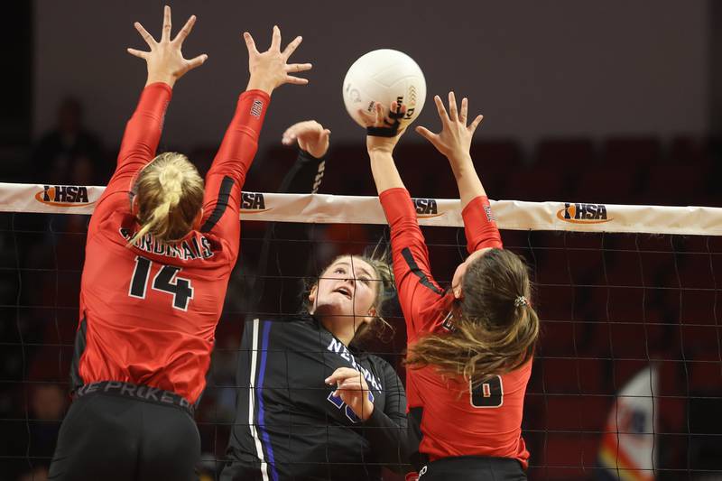 Newman’s Kennedy Rowzee powers a shot through the defense of Norris City-Omaha-Enfield's Hollan Everett (14) and Bree Vollman (6) during the Class 1A third-place match Saturday morning in Normal.