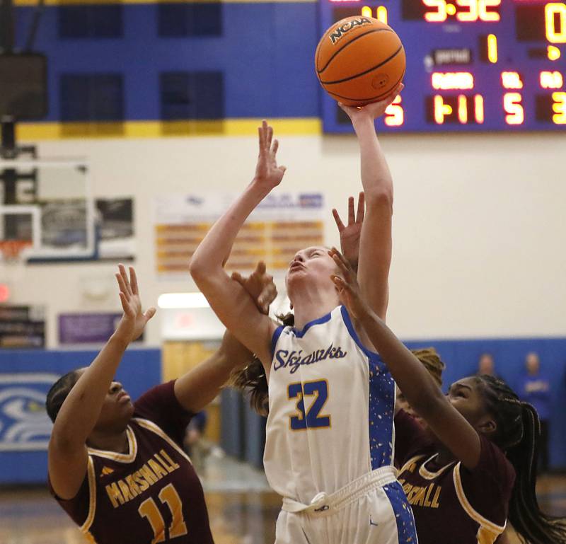 Johnsburg's Skye Toussaint tries to shoot the ball between Chicago Marshall's Anabel Robinson (left) and Monay Robinson (right) during a IHSA Class 2A Johnsburg Sectional girls basketball semifinal game on Tuesday, February, 24, 2026, at Johnsburg High School.