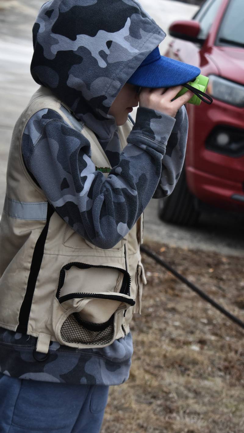 Aust Boote, 9, of Mt. Prospect, admires the eagles through his binoculars at the Rock Falls lower dam Saturday, Feb. 8, 2025, at Flock to the Rock in Rock Falls. Rock Falls is a  safe sanctuary for bald eagles. They can be found at Lawrence Park, RB&W Park, Seward's Park and the Sinnissippi Dam walking bridge.
