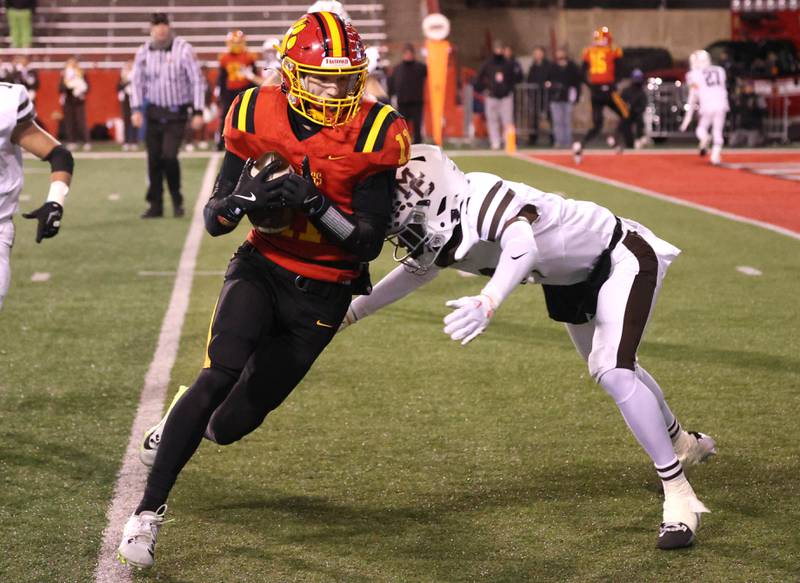 Batavia's Brett Berggren catches a pass in front of Mt. Carmel's Tavares Harrington during their Class 8A state championship game Saturday, Nov. 30, 2024, in Hancock Stadium at Illinois State University in Normal.