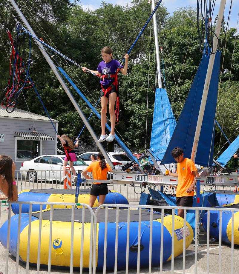 A girl jumps on the Eurobungy at Yorkville River Fest on Saturday, July 19, 2025.