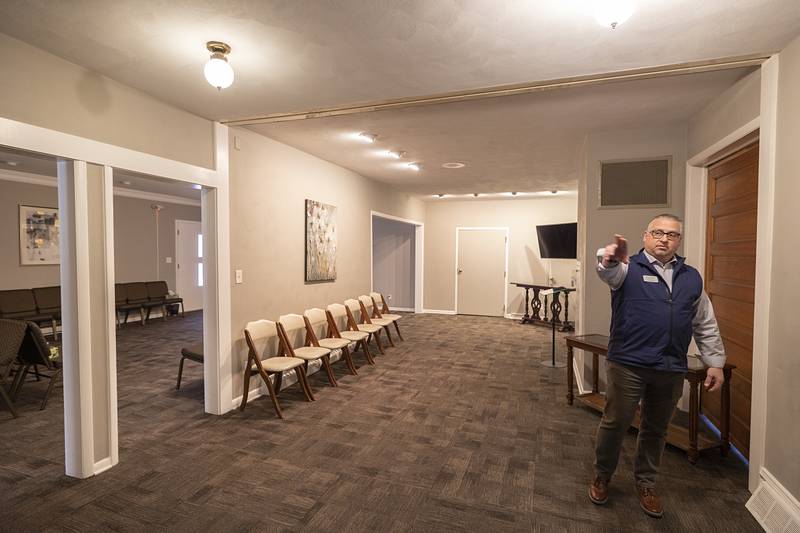 Partington gestures while touring the current funeral home Thursday, Feb. 12, 2026, in Dixon. The new facility will double the space and offer more room in the chapel area.