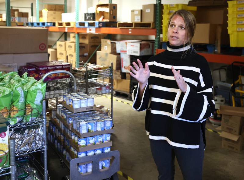 Rooted for Good Executive Director Heather Edwards talks Thursday, Oct. 30, 2025, at the food pantry, about the potential impact on Rooted for Good if SNAP benefits are cut off due to the government shut down and the large influx of new patrons it may bring.