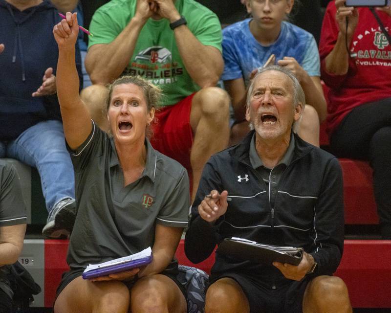 LaSalle-Peru coaches Mark Haberkorn (right) and Laura Urbanski (left) celebrate a point won during the home game against Sycamore on September 14, 2023.