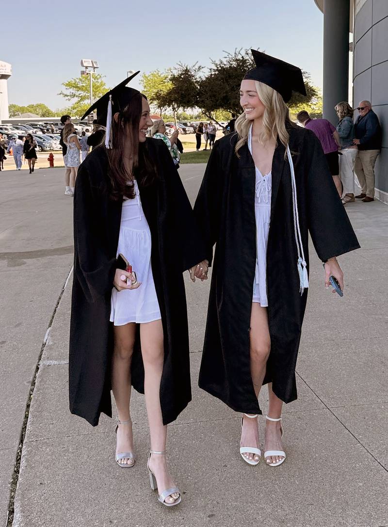 Madeleine Hamilton and Abigail Lechocki head into the NIU Convocation Center in DeKalb on Sunday, May 18, 2025.