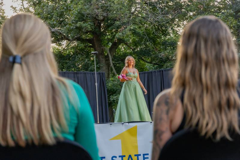 Lauren Holland makes her first appearance on stage as she is closely studied by two of the judges during the 2025 Mendota Sweet Corn pageant on August 8, 2025 in Mendota.