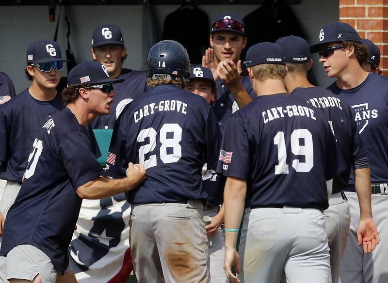 Cary-Grove's Brock Iverson is treated by his teammates after score a run during the IHSA Class 3A Grayslake Central Sectional semifinal baseball game against Prairie Ridge on Wednesday, June 4, 2025, at Grayslake Central High School.