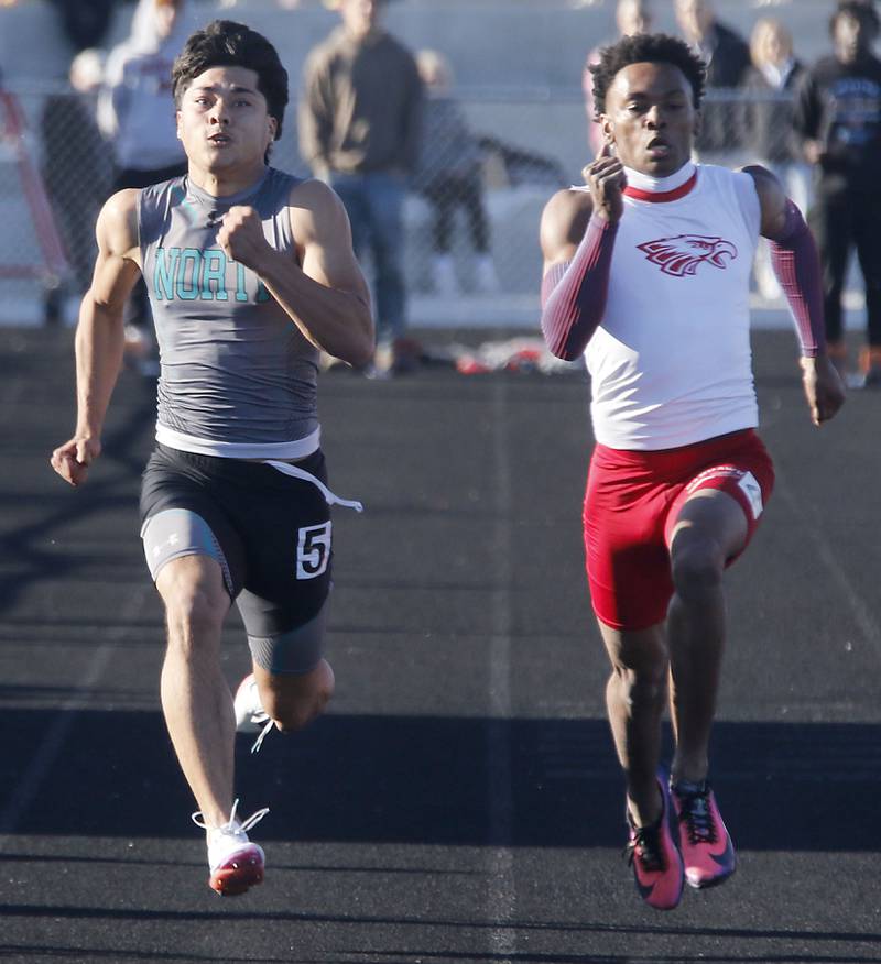 Woodstock North's Adan Castaneda battles North Chicago’s Marlin Jeffries Jr. in the 100 meter dash during the IHSA Class 2A Richmond-Burton Sectional Boys Track and Field Meet on Wednesday, May 20, 2026, at Richmond-Burton High School.