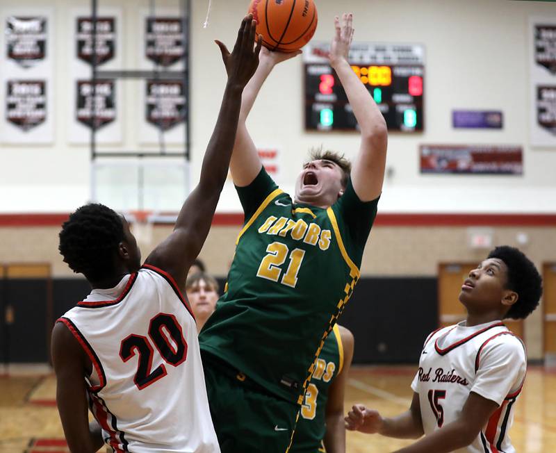 Crystal Lake South's Ryan Morgan shoots the ball between Huntley's Isaiah Onu (left) and Isaac Muze (right) during a Fox Valley Conference boys basketball game on Wednesday, Dec. 10, 2025, at Huntley High School.
