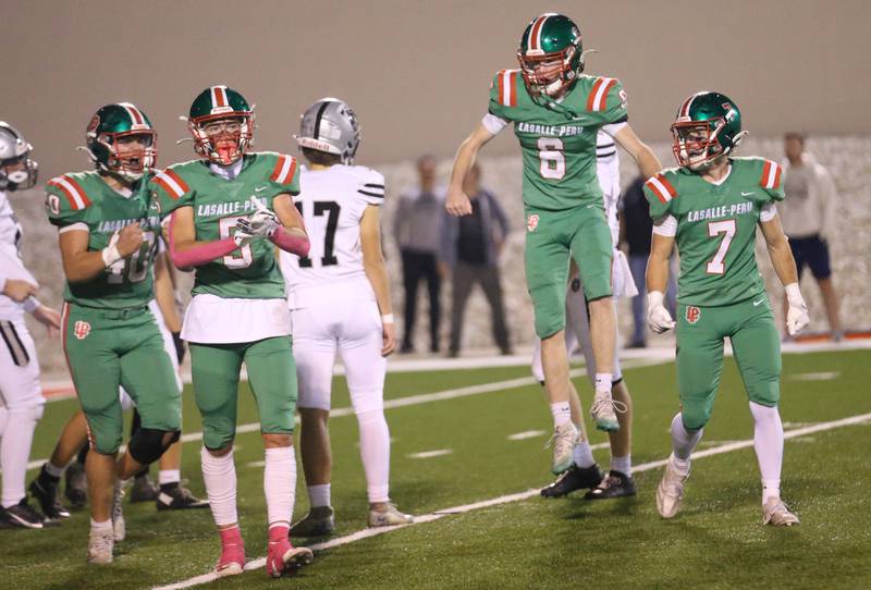 L-P football players (from left) Nick Hachenberger, Regan Doerr and Gio Legrenzi celebrate after blocking a field goal against Kaneland on Friday, Oct. 17, 2025 at Howard Fellows Stadium.