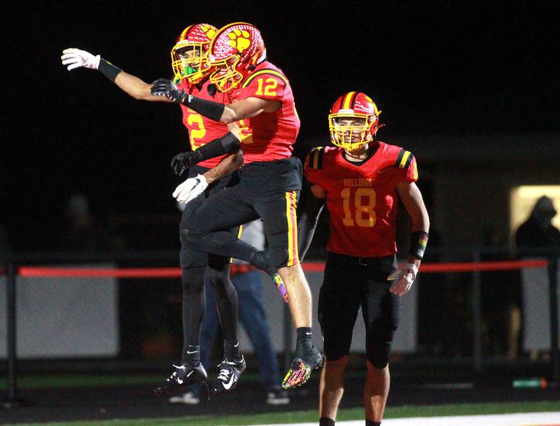 Batavia’s Isaiah Brown (left) and Luke Alwin celebrate Brown’s touchdown in the end zone during a Class 7A round 1 playoff game against Brother Rice in Batavia on Friday, Oct. 27, 2023.