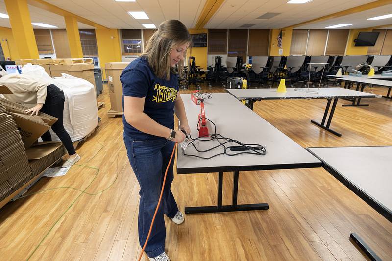 Sterling FFA President Grace Wetzell plugs in machines that will seal the bag of the food Wednesday, Nov. 6, 2024.