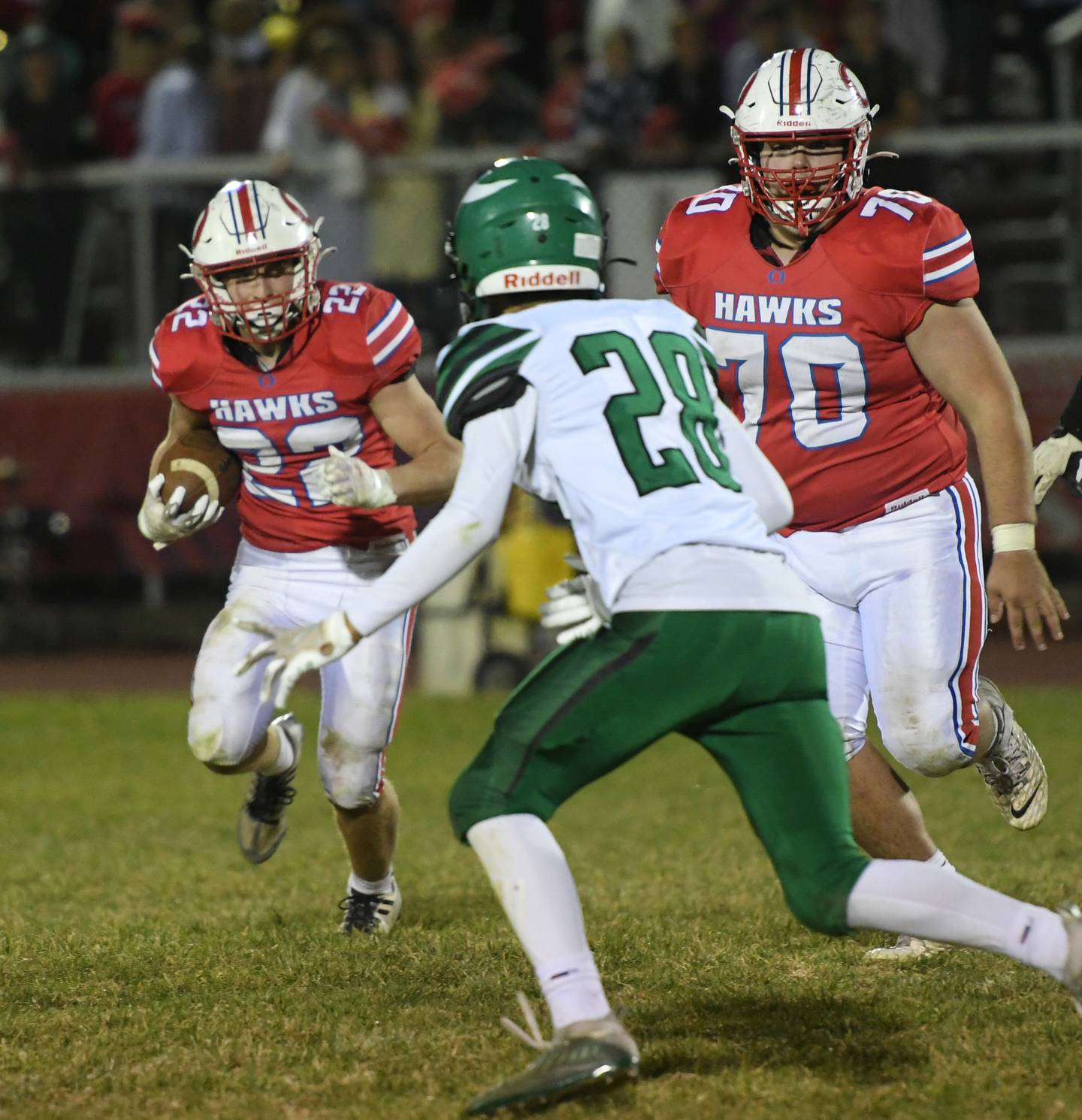 Oregon's Gabe Eckerd looks to avoid a North Boone defender as Briggs Sellers (70) looks to block during Oct. 21 action at Landers-Loomis Field.