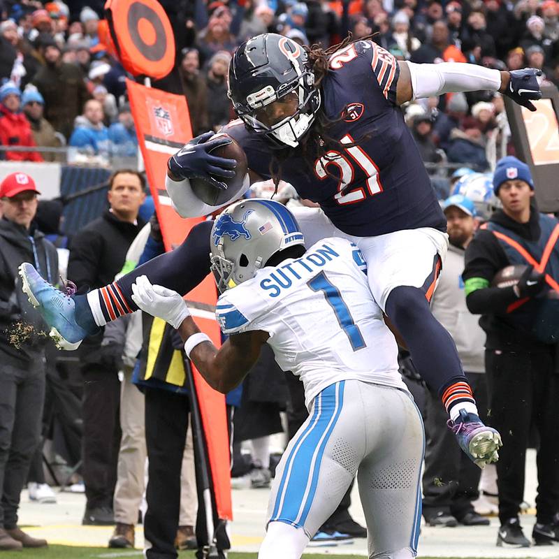 Chicago Bears running back D'Onta Foreman hurdles Detroit Lions cornerback Cameron Sutton during their game Sunday, Dec. 10, 2023 at Soldier Field in Chicago.