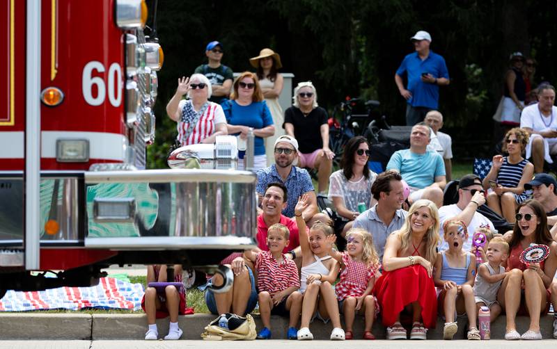 Spectators wave to a Glen Ellyn Fire Department truck on Crescent Boulevard during Glen Ellyn’s “4th of July Parade” on Friday, July 4, 2025.