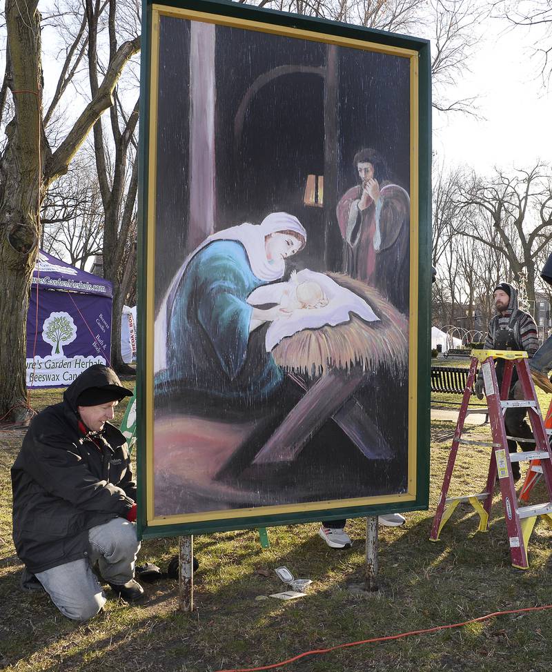 Many volunteers were on hand Saturday, Dec. 3, 2022, to erect 16 large paintings of the life of Jesus Christ in Ottawa's Washington Square.