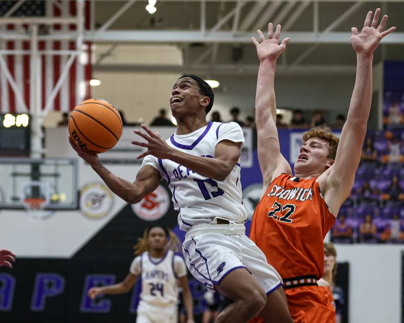 Plano's Amari Bryant (13) goes up for an acrobatic layup during their basketball game between Sandwich at Plano. Jan 27, 2025 in Plano.