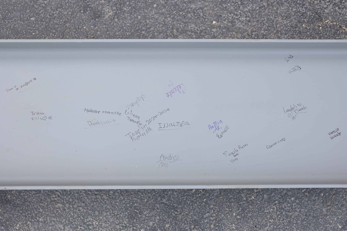 Hufford Junior High School students sign a beam that will be used to build the new school on Friday, Dec. 13, 2024 in Joliet.