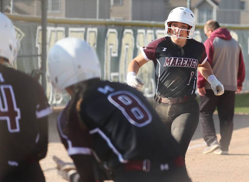 Marengo's Gabby Christopher heads home to her waiting teammates after her second home run of the day Friday, April 11, 2025, during their game at Sycamore High School.