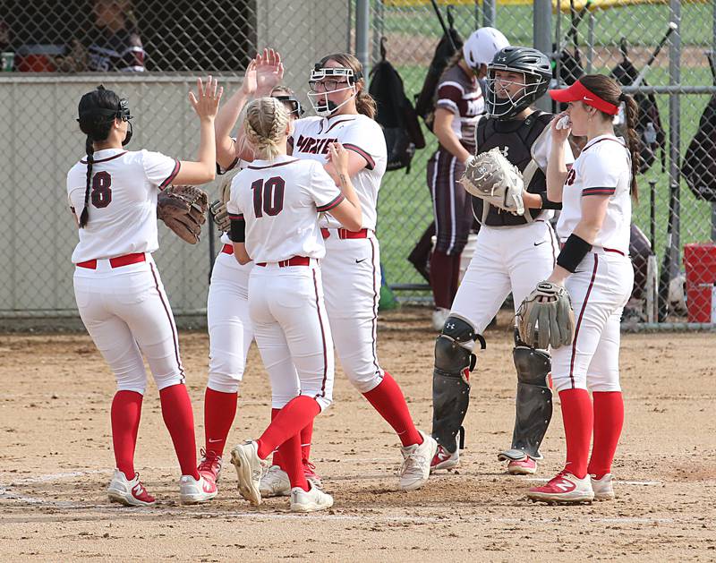Members of the Ottawa softball team huddle between innings while playing Morris on Monday, May 15, 2023 at Ottawa High School.